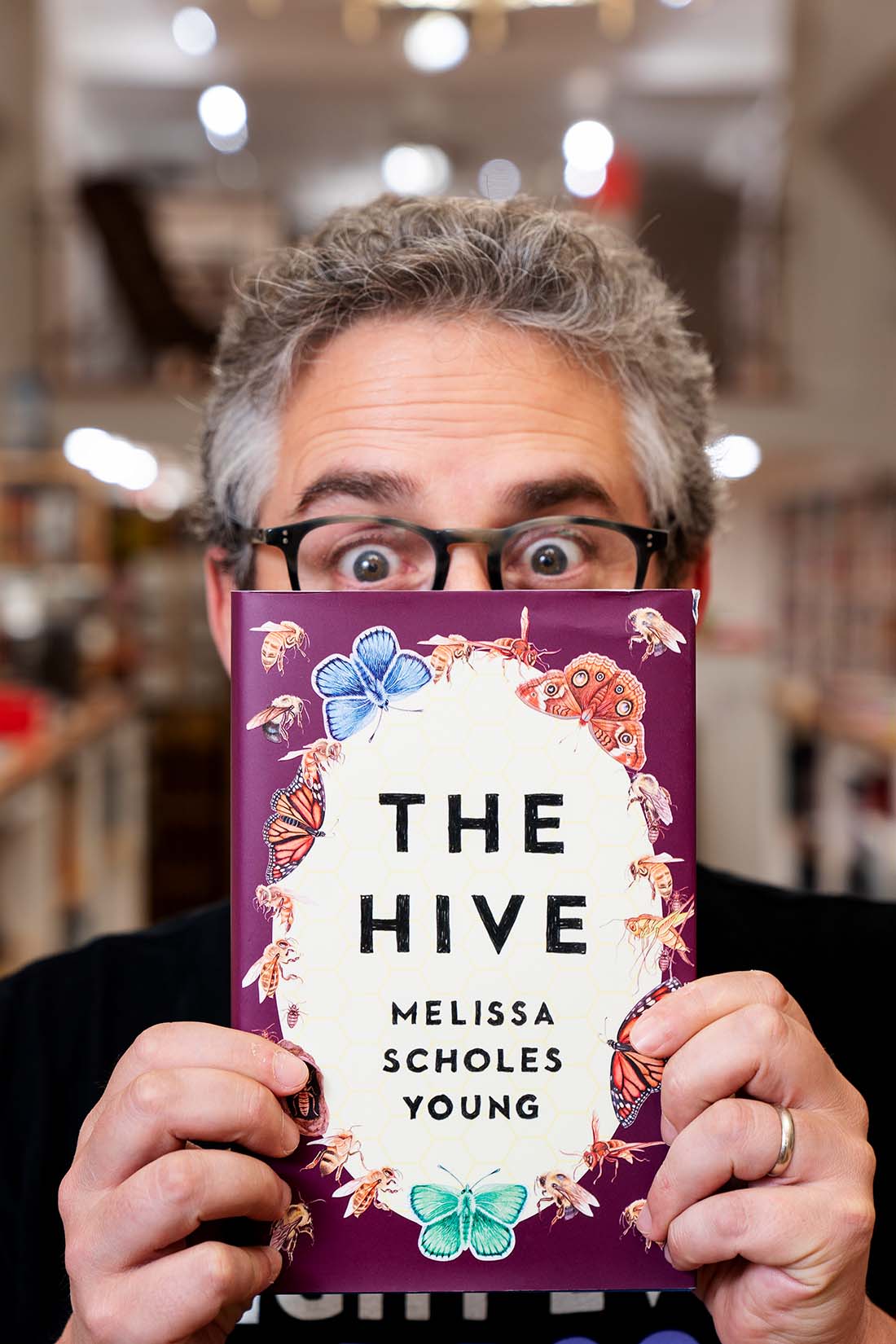 Alex George holds a copy of Melissa Scholes Young's book, The Hive