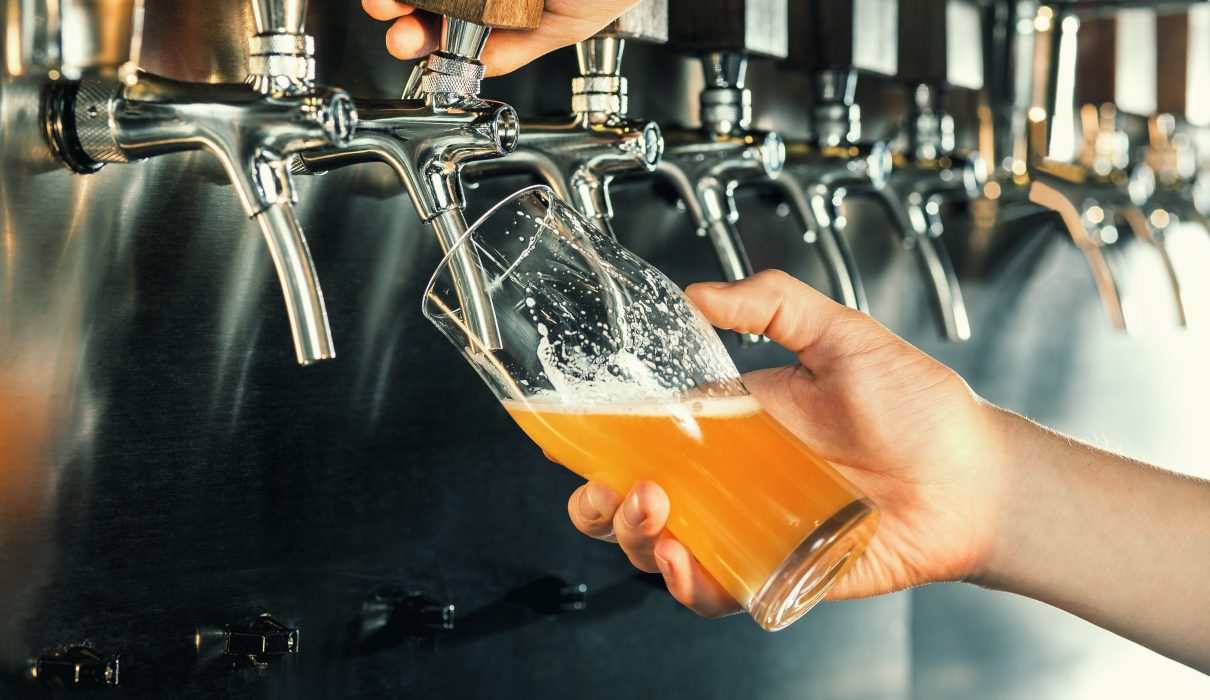 Hand,Of,Bartender,Pouring,A,Large,Lager,Beer,In,Tap.
