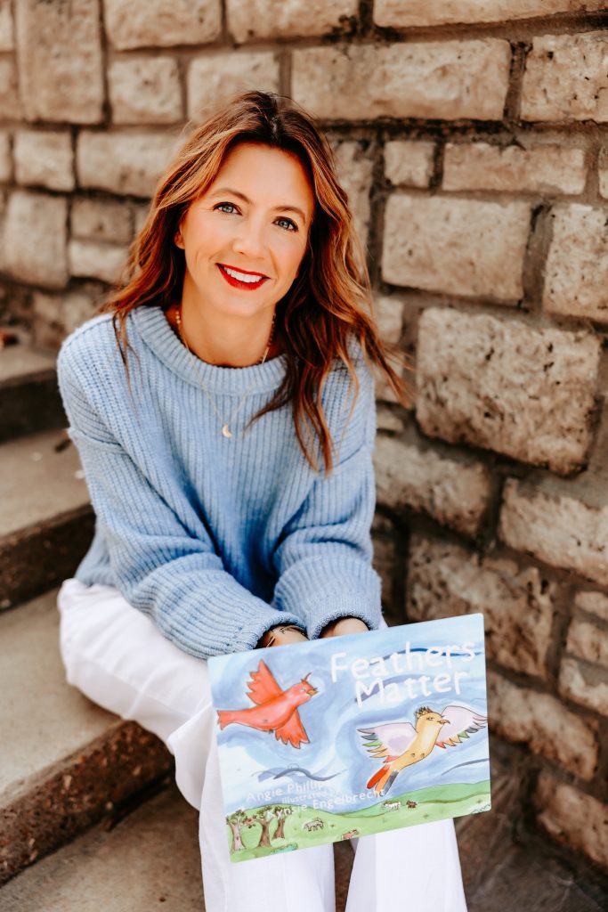 author angie phillips holding her first book