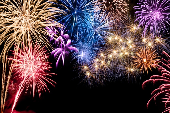 Gorgeous multi-colored fireworks display on black background, with copyspace