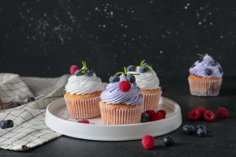 plate,of,delicious,cupcakes,with,blueberries,,raspberries,and,mint,on