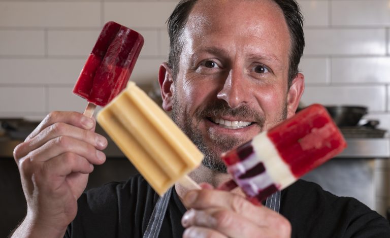 Chef Brook Harlan holding up three popsicles