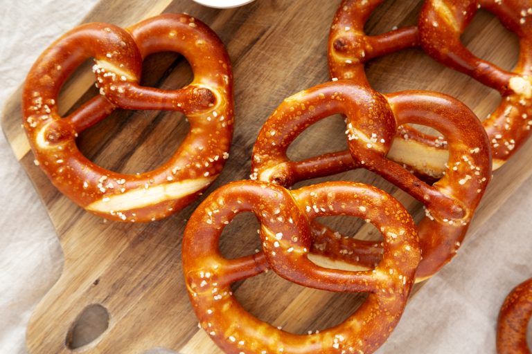 homemade,soft,bavarian,pretzels,with,mustard,on,a,wooden,board,