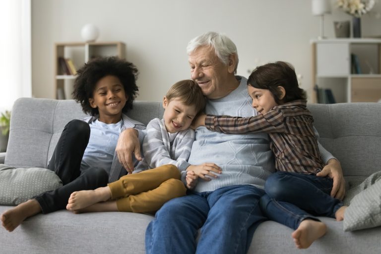 three,loving,cute,multiracial,great grandsons,cuddling,his,grey haired,old,great grandpa