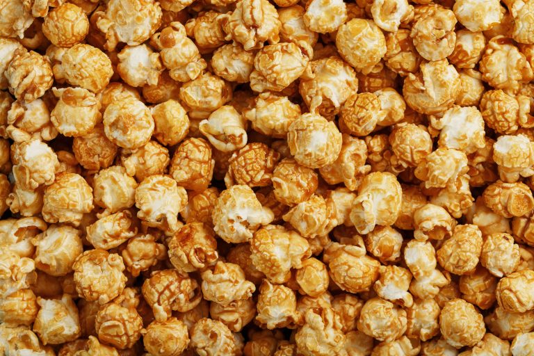 popcorn,in,caramel,glaze,close up,as,a,background.,delicious,praise