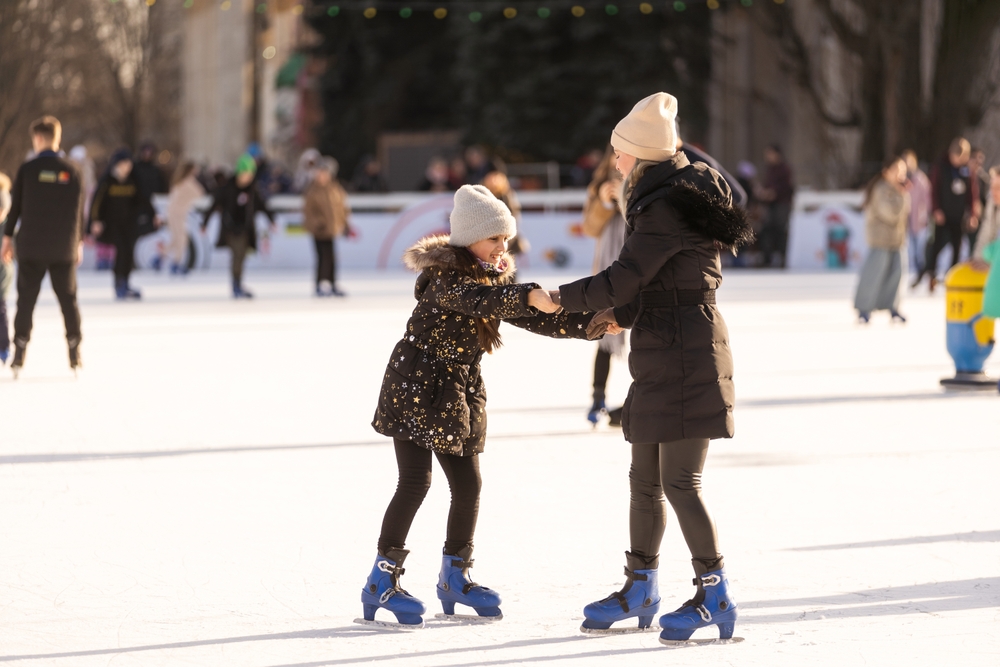 beautiful,happy,mother,and,daughter,smiling,at,camera,while,standing